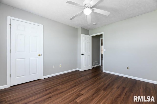2331 W Molly Ln, Dunlap, IL 61525 - unfurnished bedroom with dark wood finished floors, baseboards, and a ceiling fan
