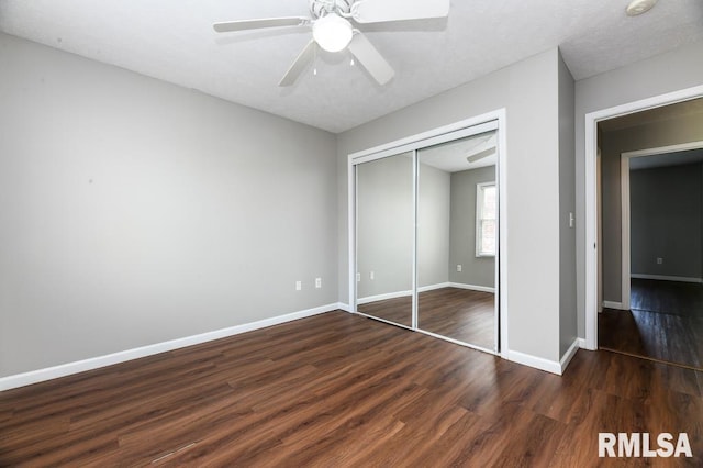 2331 W Molly Ln, Dunlap, IL 61525 - unfurnished bedroom with dark wood finished floors, a closet, baseboards, and ceiling fan