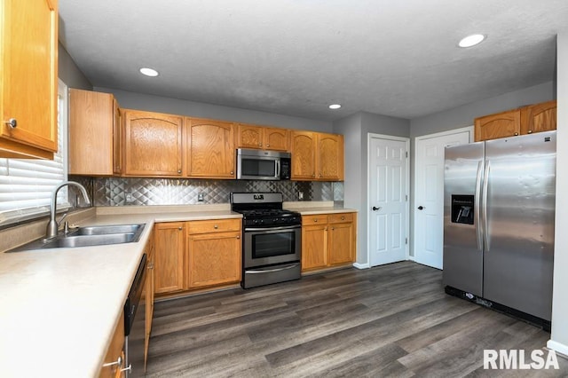 2331 W Molly Ln, Dunlap, IL 61525 - kitchen with appliances with stainless steel finishes, a sink, light countertops, dark wood-style floors, and recessed lighting