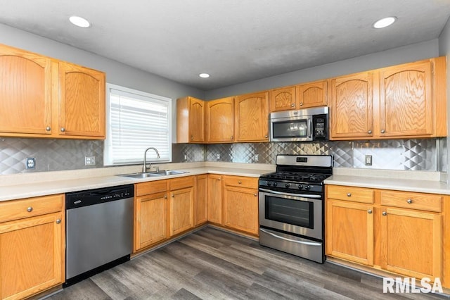2331 W Molly Ln, Dunlap, IL 61525 - kitchen with appliances with stainless steel finishes, a sink, light countertops, dark wood-style flooring, and recessed lighting