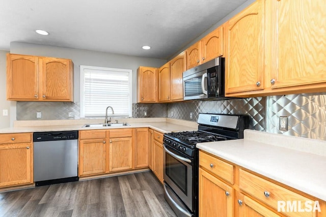 2331 W Molly Ln, Dunlap, IL 61525 - kitchen featuring appliances with stainless steel finishes, a sink, dark wood finished floors, light countertops, and tasteful backsplash