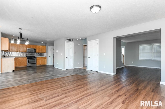 2331 W Molly Ln, Dunlap, IL 61525 - unfurnished living room with baseboards, wood finished floors, and a textured ceiling