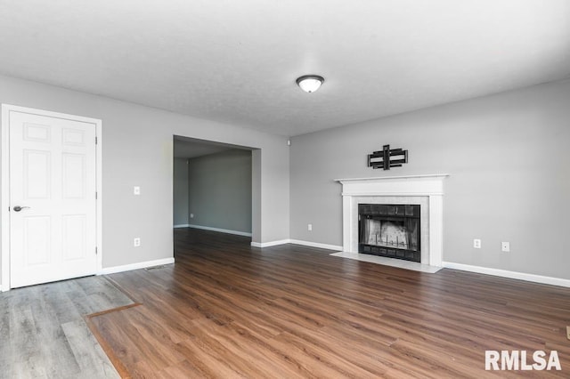 2331 W Molly Ln, Dunlap, IL 61525 - unfurnished living room with a tile fireplace, wood finished floors, and baseboards