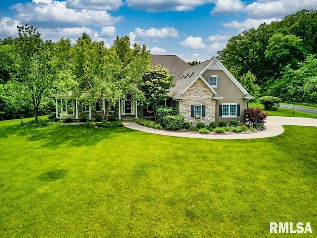 1112 W Cedar Hills Dr, Dunlap, IL 61525 - view of front of house featuring stone siding, a front yard, and stucco siding