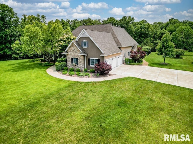 1112 W Cedar Hills Dr, Dunlap, IL 61525 - view of front of house with concrete driveway, stone siding, a front lawn, and stucco siding