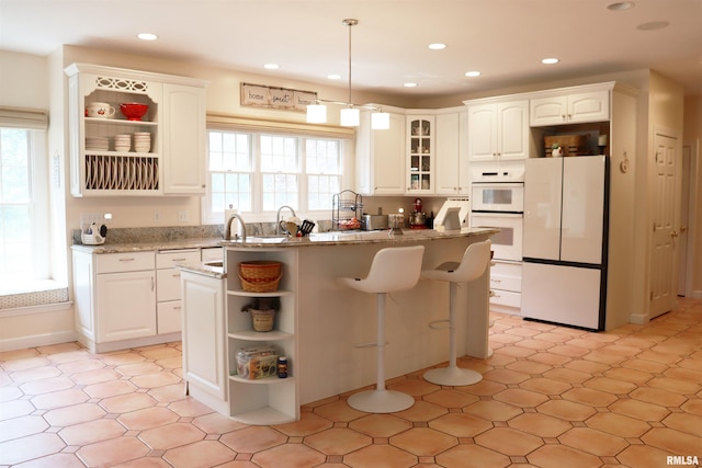 1112 W Cedar Hills Dr, Dunlap, IL 61525 - kitchen with white appliances, open shelves, white cabinetry, glass insert cabinets, and recessed lighting