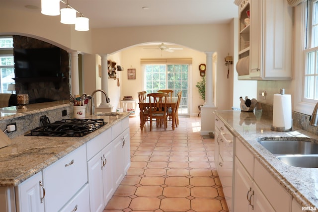 1112 W Cedar Hills Dr, Dunlap, IL 61525 - kitchen featuring ornate columns, healthy amount of natural light, arched walkways, and a sink