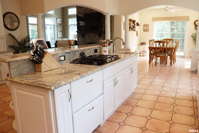 1112 W Cedar Hills Dr, Dunlap, IL 61525 - kitchen featuring a sink, decorative columns, black gas stovetop, and arched walkways
