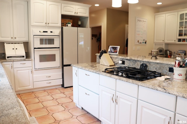 1112 W Cedar Hills Dr, Dunlap, IL 61525 - kitchen featuring white appliances, recessed lighting, glass insert cabinets, white cabinetry, and light stone counters