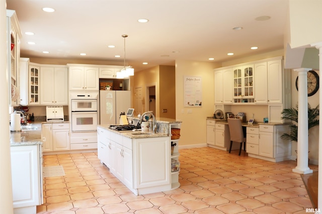1112 W Cedar Hills Dr, Dunlap, IL 61525 - kitchen featuring recessed lighting, a center island with sink, white cabinets, white appliances, and hanging light fixtures