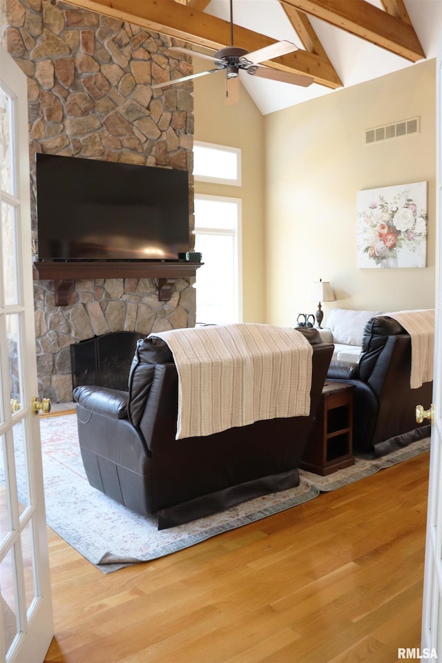 1112 W Cedar Hills Dr, Dunlap, IL 61525 - bedroom featuring wood finished floors, beam ceiling, a fireplace, high vaulted ceiling, and a ceiling fan