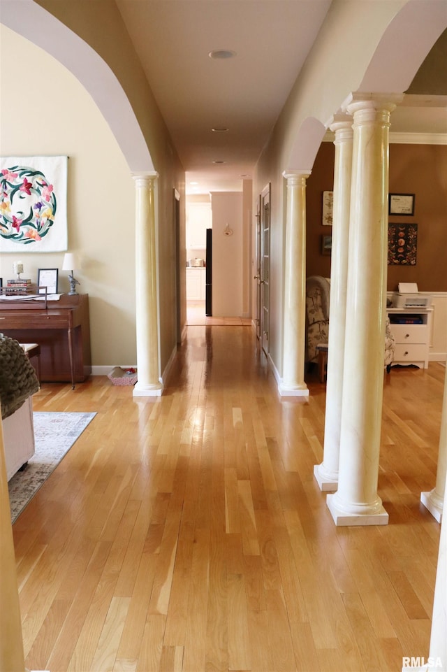 1112 W Cedar Hills Dr, Dunlap, IL 61525 - hall with ornate columns, arched walkways, and light wood-style floors