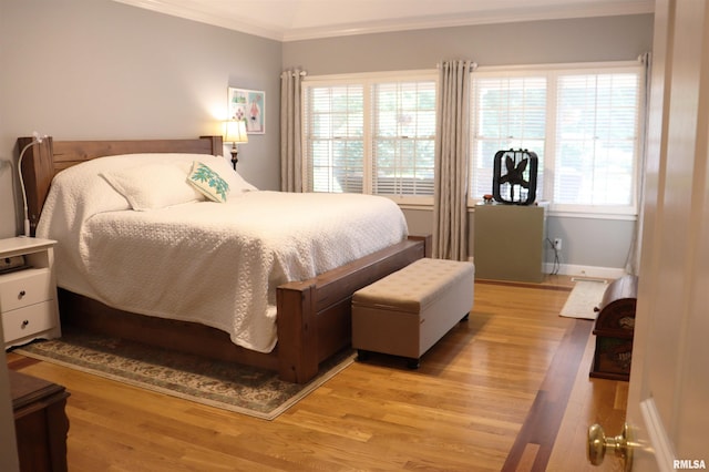 1112 W Cedar Hills Dr, Dunlap, IL 61525 - bedroom featuring ornamental molding, light wood-style floors, and baseboards