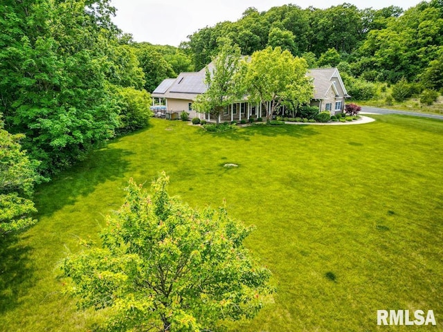 1112 W Cedar Hills Dr, Dunlap, IL 61525 - view of grassy yard featuring covered porch and a wooded view