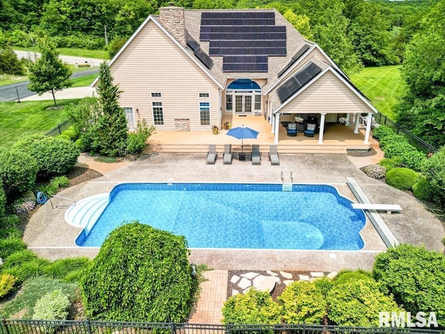 1112 W Cedar Hills Dr, Dunlap, IL 61525 - view of pool with a wooden deck, a diving board, an outdoor hangout area, outdoor dining space, and a patio area