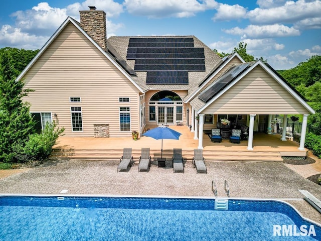 1112 W Cedar Hills Dr, Dunlap, IL 61525 - rear view of property featuring an outdoor living space, roof with shingles, solar panels, and an outdoor pool