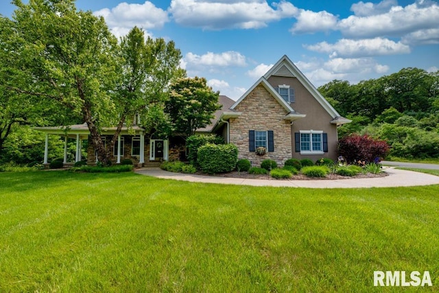 1112 W Cedar Hills Dr, Dunlap, IL 61525 - view of front of property with stone siding, stucco siding, and a front lawn