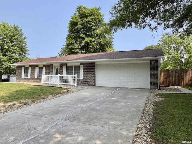 1612 Joyce Ln, Macomb, IL 61455 - ranch-style home with covered porch, concrete driveway, brick siding, and a garage