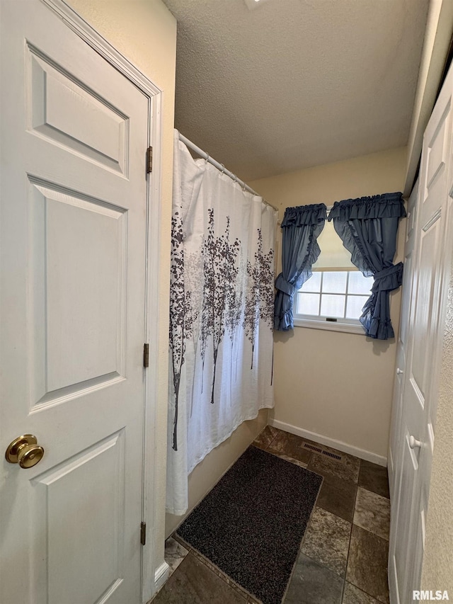 1612 Joyce Ln, Macomb, IL 61455 - entryway with stone finish floors and a textured ceiling