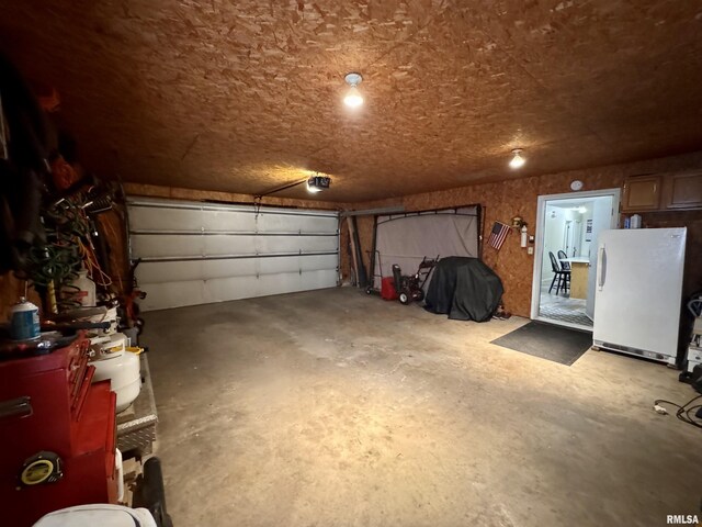 1612 Joyce Ln, Macomb, IL 61455 - garage featuring freestanding refrigerator and a garage door opener