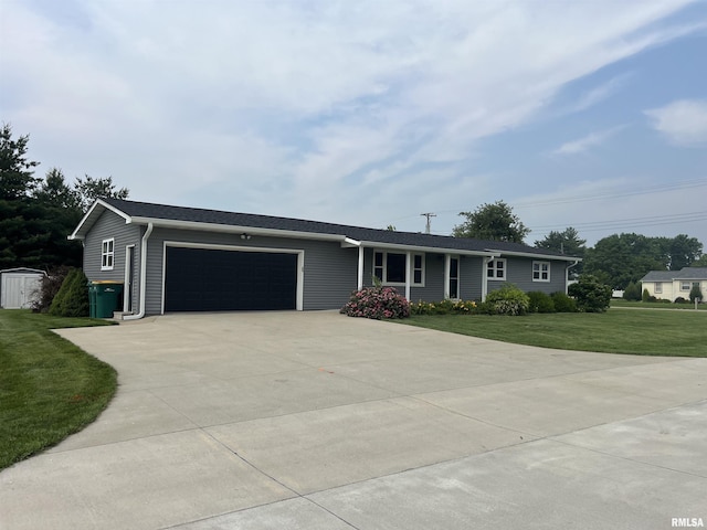 1302 Maple Ave, Macomb, IL 61455 - ranch-style house with an attached garage, concrete driveway, and a front lawn