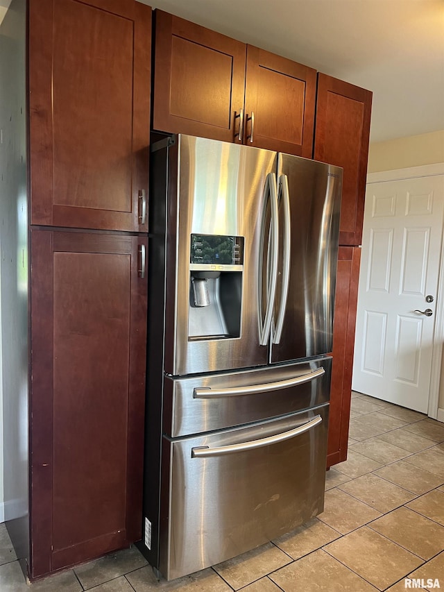 1302 Maple Ave, Macomb, IL 61455 - kitchen with stainless steel fridge with ice dispenser, light tile patterned flooring, and brown cabinetry
