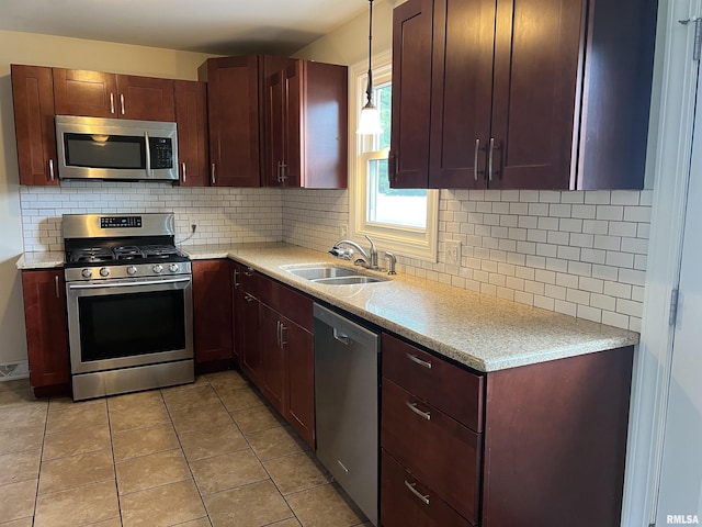 1302 Maple Ave, Macomb, IL 61455 - kitchen featuring appliances with stainless steel finishes, a sink, backsplash, and hanging light fixtures
