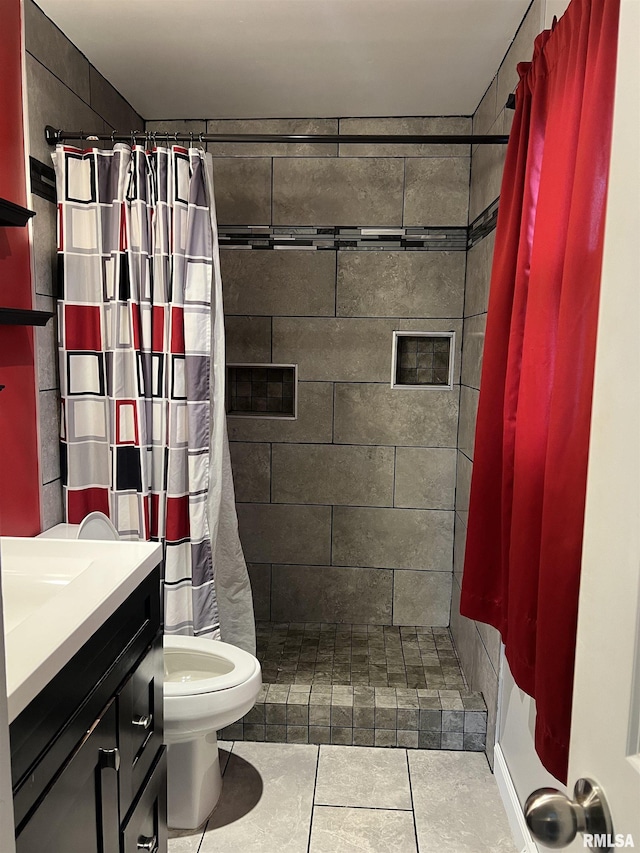 1302 Maple Ave, Macomb, IL 61455 - bathroom featuring tiled shower, toilet, vanity, and tile patterned flooring