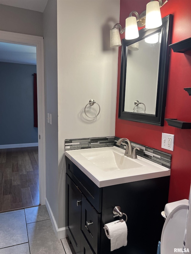 1302 Maple Ave, Macomb, IL 61455 - half bath with vanity, baseboards, and tile patterned floors