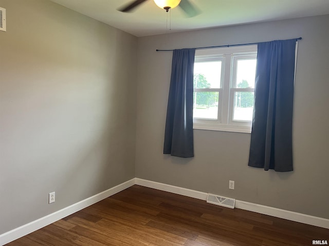 1302 Maple Ave, Macomb, IL 61455 - unfurnished room with a ceiling fan, dark wood finished floors, and baseboards