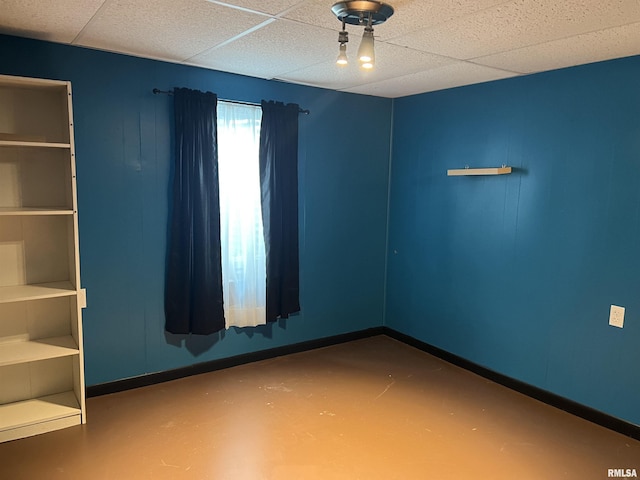 1302 Maple Ave, Macomb, IL 61455 - spare room featuring finished concrete flooring and baseboards
