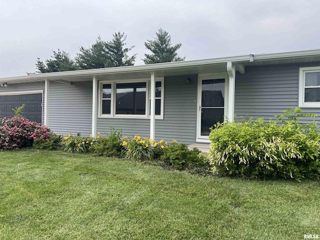 1302 Maple Ave, Macomb, IL 61455 - view of property exterior with a garage and a lawn