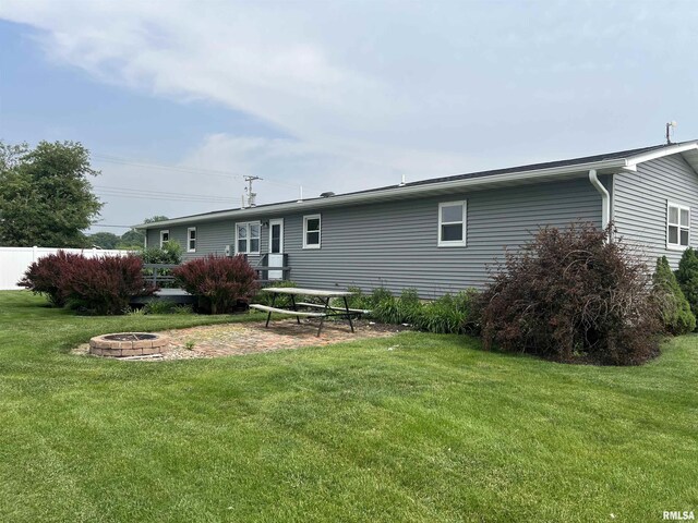 1302 Maple Ave, Macomb, IL 61455 - rear view of house featuring a fire pit and a patio area