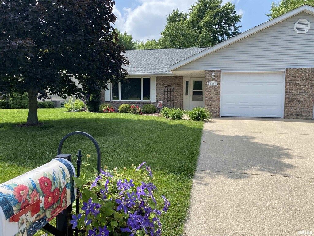 1661 E Myrtle St, Canton, IL 61520 - view of front of property featuring brick siding, a front lawn, driveway, an attached garage, and roof with shingles