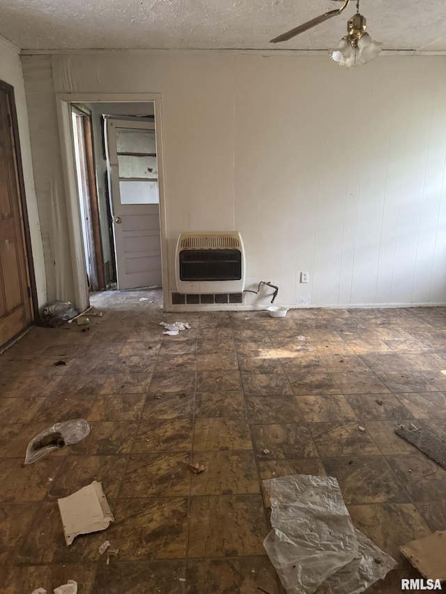 2432 W Antoinette St, Peoria, IL 61605 - unfurnished living room with heating unit, ceiling fan, and a textured ceiling