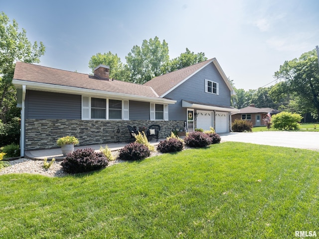 2010 E Paris Ave, Peoria, IL 61614 - view of front of home featuring a chimney, a garage, a front yard, driveway, and stone siding