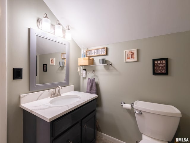 2010 E Paris Ave, Peoria, IL 61614 - bathroom featuring vaulted ceiling and vanity