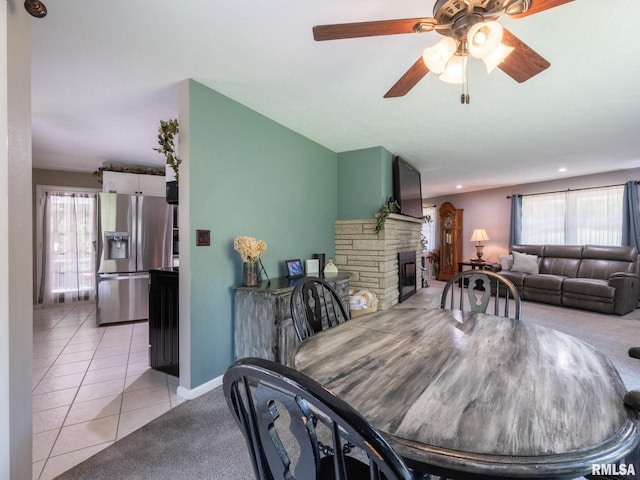 2010 E Paris Ave, Peoria, IL 61614 - dining area with plenty of natural light, a ceiling fan, a fireplace, and light tile patterned flooring