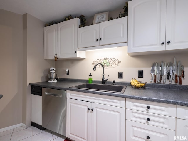 2010 E Paris Ave, Peoria, IL 61614 - kitchen with stainless steel dishwasher, dark countertops, light tile patterned flooring, and white cabinets