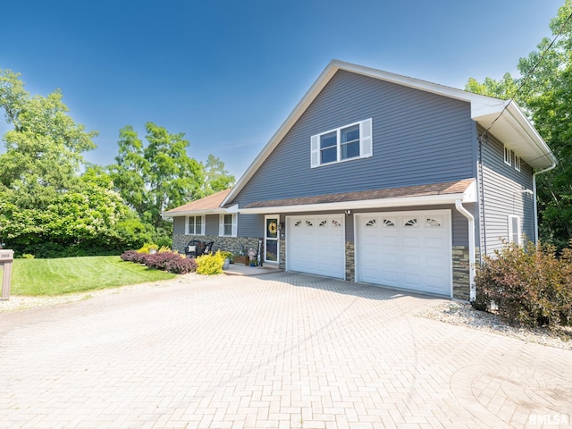2010 E Paris Ave, Peoria, IL 61614 - traditional-style house with decorative driveway, a garage, stone siding, and a front lawn