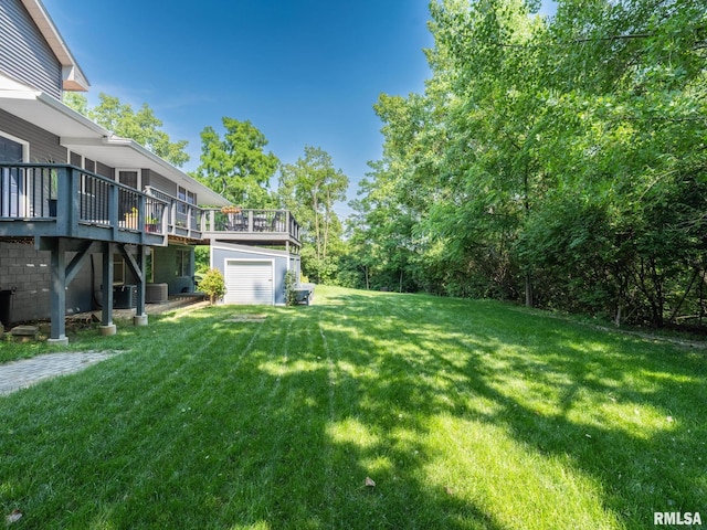 2010 E Paris Ave, Peoria, IL 61614 - view of grassy yard featuring a wooden deck, a garage, and driveway