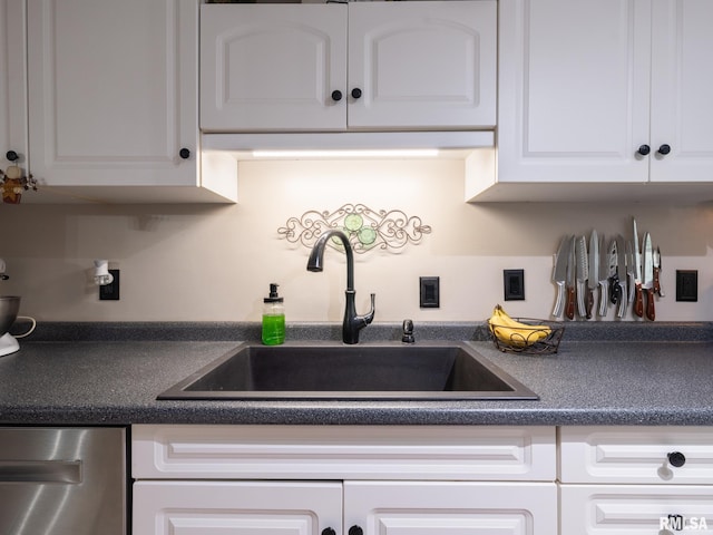 2010 E Paris Ave, Peoria, IL 61614 - kitchen with dishwasher, dark countertops, and white cabinets