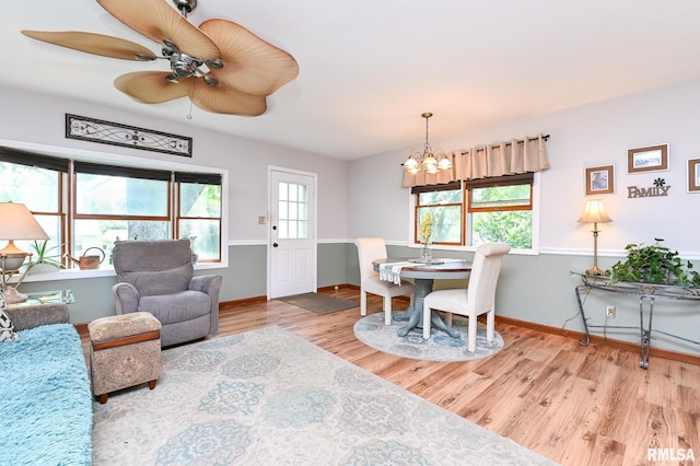 4126 N Chelsea Pl, Peoria, IL 61614 - dining area with a chandelier, wood finished floors, and a ceiling fan
