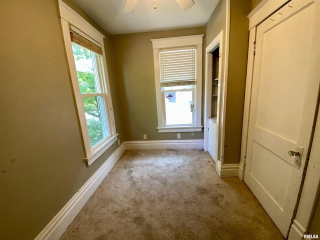 1502 W Columbia Ter, Peoria, IL 61606 - spare room featuring light carpet, plenty of natural light, baseboards, and ceiling fan