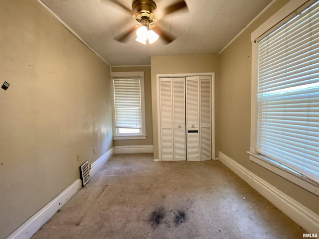 1502 W Columbia Ter, Peoria, IL 61606 - unfurnished bedroom featuring a closet, baseboards, crown molding, and ceiling fan