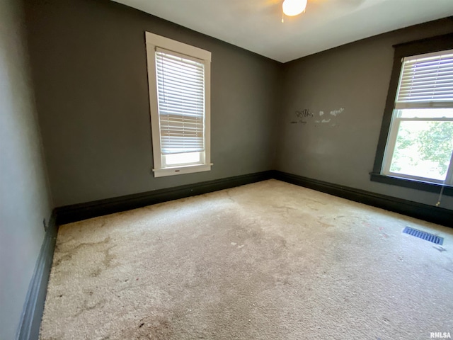 1502 W Columbia Ter, Peoria, IL 61606 - spare room with healthy amount of natural light, carpet, and a ceiling fan