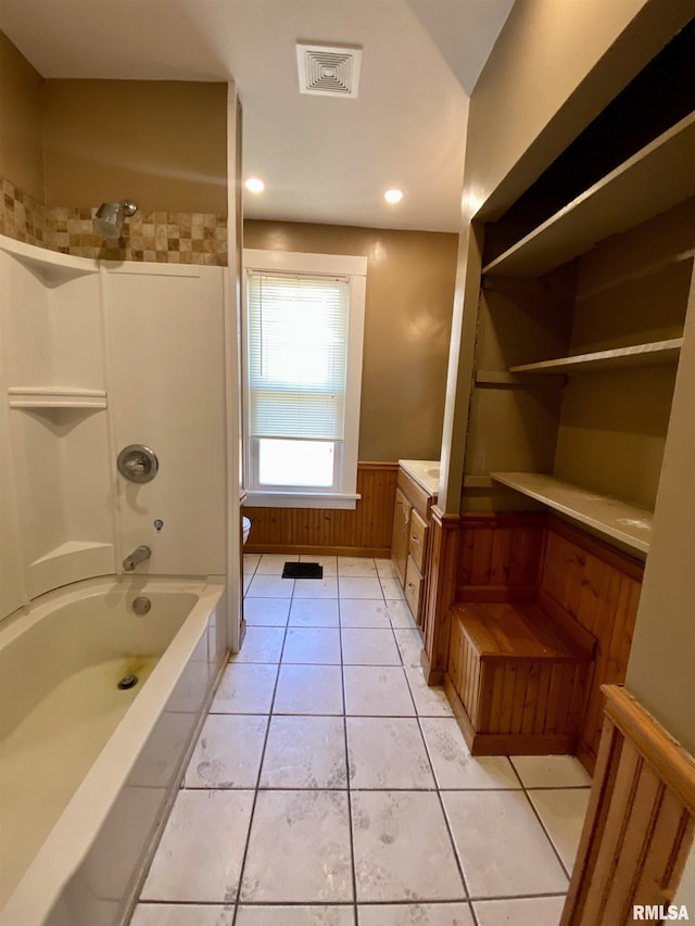 1502 W Columbia Ter, Peoria, IL 61606 - full bath featuring toilet, a wainscoted wall, washtub / shower combination, tile patterned flooring, and vanity
