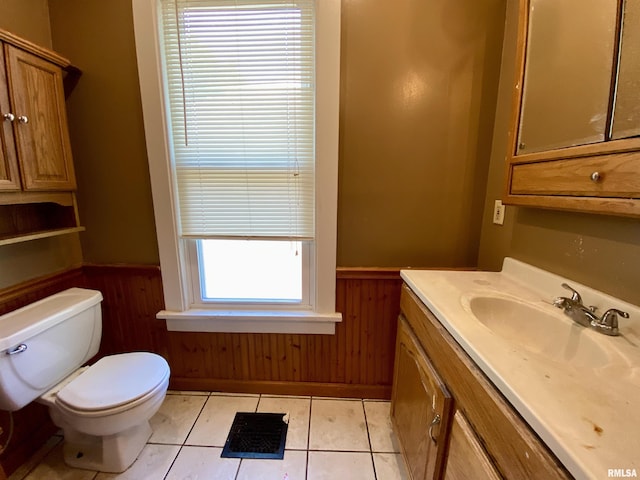 1502 W Columbia Ter, Peoria, IL 61606 - half bath featuring toilet, wainscoting, vanity, tile patterned floors, and wooden walls