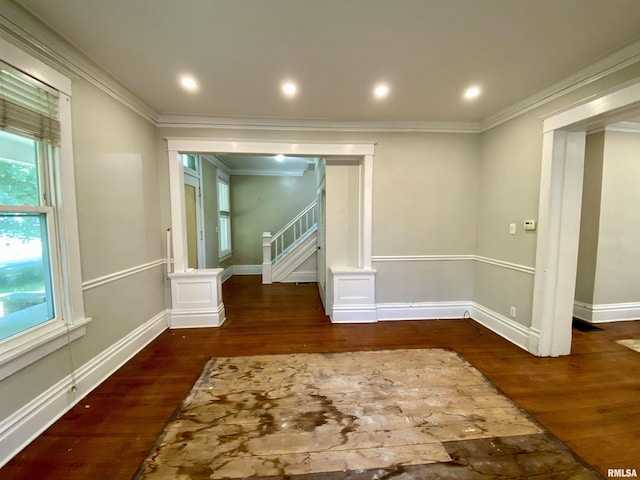 1502 W Columbia Ter, Peoria, IL 61606 - spare room featuring wood finished floors, crown molding, stairway, ornate columns, and baseboards