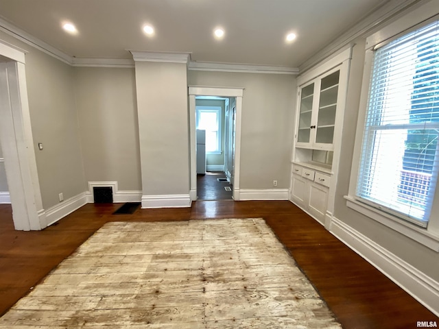 1502 W Columbia Ter, Peoria, IL 61606 - empty room featuring crown molding, dark wood finished floors, and baseboards